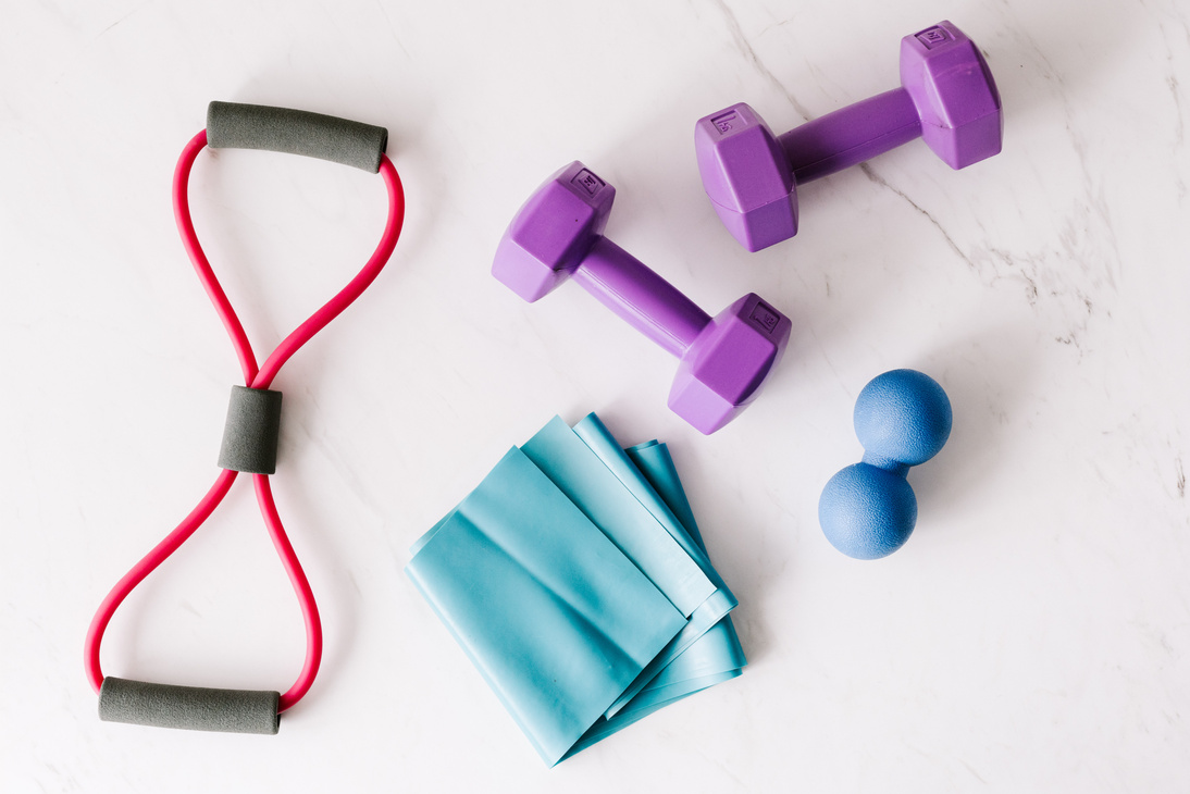 Set of fitness equipment placed on marble surface