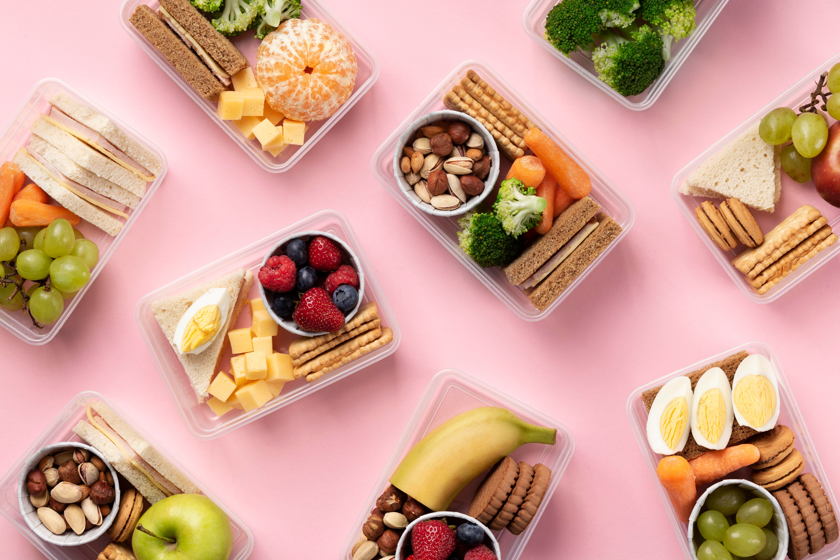 Composition of Healthy Food Boxes on Pink Background